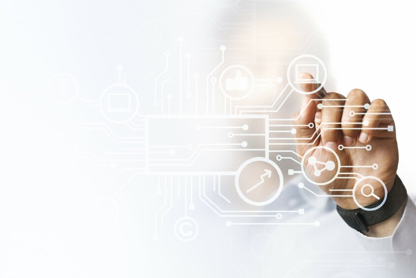  A hand presses production symbols on a futuristic display, surrounded by modern digital graphics and user interfaces. The image symbolizes quality assurance in tool manufacturing.